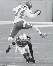  ?? CHARLES TRAINOR ctrainor@miamiheral­d.com ?? Chiefs wide receiver Sammy Watkins leaps over Dolphins strong safety Bobby McCain in a December 2020 game.