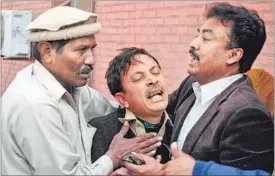  ??  ?? A man cries over the death of his relative, who was killed in an explosion in a Shia mosque, outside a hospital in Peshawar on Friday. REUTERS