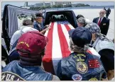  ?? CHRIS URSO / TAMPA BAY TIMES ?? ABOVE: The casket with the remains of Mark Dennis is loaded into a hearse by Patriot Guard members Tuesday at Tampa Internatio­nal Airport.