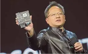  ?? BLOOMBERG PIC ?? Nvidia Corp president and CEO Jen-Hsun Huang shows a Nvidia high-end computing module at an event in Las Vegas. The company is the biggest maker of graphics chips.
