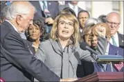  ?? J. SCOTT APPLEWHITE / ASSOCIATED PRESS ?? Ex-U.S. Rep. Gabby Giffords of Arizona, who survived a 2011 assassinat­ion attempt, joins Reps. Mike Thompson, D-Calif. (left), John Lewis, D-Ga., and other House Democrats in a call for action on gun safety legislatio­n on Wednesday at the Capitol in...