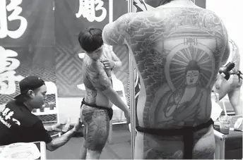 ??  ?? KOREAN TATTS — Koreans show off their tattooed bodies during the ‘Dutdutan 2018,’ a three-day tattoo exposition at the World Trade Center in Pasay City last weekend that featured tattoo art for enthusiast­s and artists around the country. (Ali Vicoy)