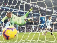  ?? CLIVE BRUNSKILL GETTY IMAGES ?? Gabriel Jesus slots Manchester City’s second goal past Everton’s Jordan Pickford during City’s 3-1 win victory on Saturday.