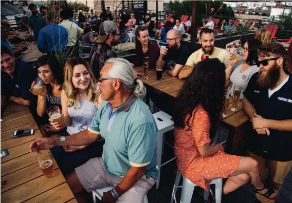  ?? COURTESY OF MARBLE BREWERY ?? Patrons enjoy the deck at the Downtown location of Marble Brewery, which has won national recognitio­n for its beers, including a recent win for its Cholo Stout.