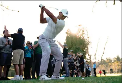  ?? The Associated Press ?? Tiger Woods hits from the rough for his second shot on the 15th hole during the second round of the Genesis Open at Riviera Country Club on Friday in Los Angeles. Woods carded a 5-over 76 and missed the cut.