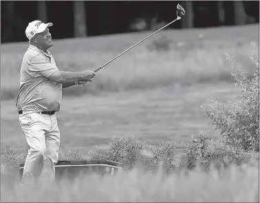  ?? SARAH GORDON/THE DAY ?? John Elliott, formerly of Norwich, laughs as he watches his tee off the 10th hole during the second day of the 38th Connecticu­t Senior Open golf championsh­ip at Shennecoss­ett Golf Course in Groton.