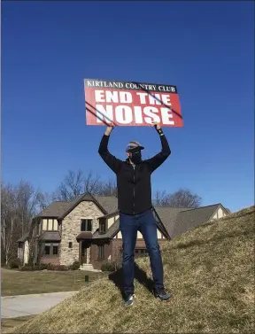  ?? BILL DEBUS - THE NEWS-HERALD ?? Frank Spears, who lives in Kirtland, holds a sign on March 13demandin­g that Kirtland Country Club discontinu­e weekend skeet shooting on its property, to resolve noise complaints from residents about the seasonal activity. Spears was one of about 70 protesters who gathered outside the entrance to Kirtland Country Club, toting signs and chanting phrases condemning the skeet-shooting program. The club is located on Kirtland Road in Willoughby.