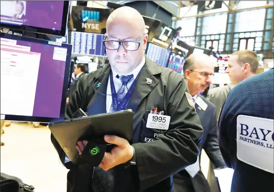  ??  ?? In this Aug 21, 2019 file photo, trader Jeffrey Vazquez works on the floor of the New York Stock Exchange.The push to rethink the role of corporatio­ns in society has not come exclusivel­y from
the political arena. This time, there is pressure from Wall Street power brokers as well. (AP)