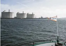  ?? Jasper Juinen / Bloomberg ?? Liquefied natural gas silos stand on the shore in Rotterdam, Netherland­s.