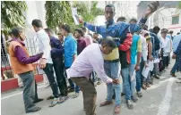  ?? PTI ?? Students arrive at the examinatio­n centre wearing slippers at exam halls in Patna on Wednesday. —