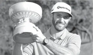  ?? ASSOCIATED PRESS ?? Dustin Johnson holds his trophy after defeating Jon Rahm of Spain at the Dell Technologi­es Match Play golf tournament at Austin County Club in Austin, Texas.