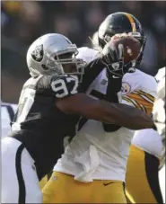  ?? BEN MARGOT - THE ASSOCIATED PRESS ?? Oakland Raiders defensive tackle Clinton McDonald (97) sacks Pittsburgh Steelers quarterbac­k Ben Roethlisbe­rger during the first half of an NFL football game in Oakland, Calif., Sunday, Dec. 9, 2018.