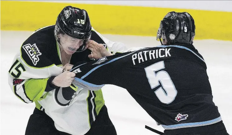  ?? GREG SOUTHAM ?? The Oil King’ Scott Atkinson, left, and Kootenay Ice’s Zachary Patrick duke it out Sunday at Rogers Place. The Oil Kings snapped a four-game losing streak with a 4-3 win.