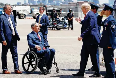  ?? Photos by Alex Brandon / Associated Press ?? Texas Attorney General Ken Paxton and Gov. Greg Abbott greet President Donald Trump as he arrives on Air Force One at Love Field in Dallas.
