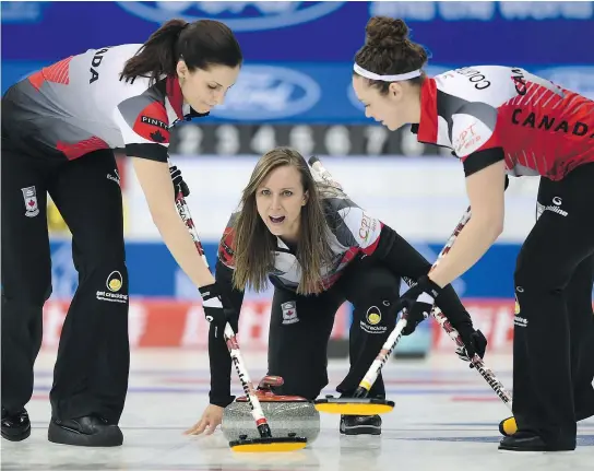  ?? — THE ASSOCIATED PRESS ?? Rachel Homan of Canada shouts as her teammates Joanne Courtney, right, and Lisa Weagle, sweep during a match against Russia in the CPT World Women’s Curling Championsh­ip 2017 in Beijing on Sunday.