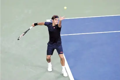  ??  ?? Roger Federer of Switzerlan­d serves to Peter Gojowczyk of Germany during their Cincinnati Masters first-round match at the Lindner Family Tennis Center in Mason, Ohio, on Tuesday. — AFP