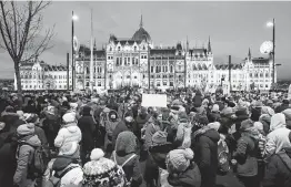  ?? Ferenc Isza / AFP / Getty Images ?? Protesters condemn Hungary’s new labor law that, among other provisions, says employers can demand 400 hours of overtime a year.