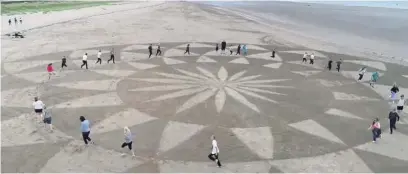  ??  ?? The sand art on Llanelli Beach.