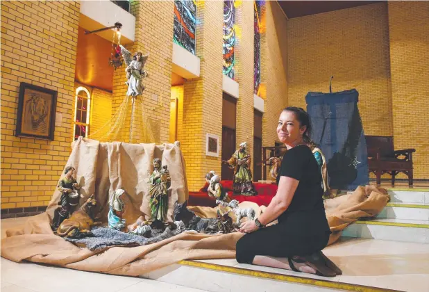  ?? Picture: BRENDAN RADKE ?? TRADITIONA­L: Catholic Diocese of Cairns administra­tion officer Lisa Skaines tends to the nativity scene at St Monica’s Cathedral.