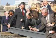  ?? Gary Kazanjian / Associated Press 2015 ?? Gov. Jerry Brown (center) and his wife, Anne Gust Brown, sign a portion of a rail at the 2015 groundbrea­king event in Fresno.