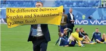  ?? Picture: AP ?? SEBASTIAN LARSSON: Holds a banner to fans after beating Switzerlan­d in the round of 16 on Tuesday.