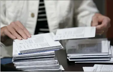  ?? KEITH SRAKOCIC — THE ASSOCIATED PRESS ?? An election worker continues the process in counting ballots for the Pennsylvan­ia primary election, Wednesday, May 18, 2022, at the Mercer County Elections Board in Mercer, Pa. Vote counting continues as Republican candidates Dr. Mehmet Oz and David McCormick are locked in a too-early-to-call race for Pennsylvan­ia’s hotly contested Republican nomination for an open U.S. Senate seat.