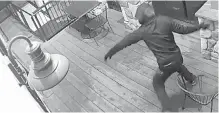  ??  ?? Surveillan­ce video shows a man smashing a window at the Cassidy Country Kitchen with a rock on Monday.