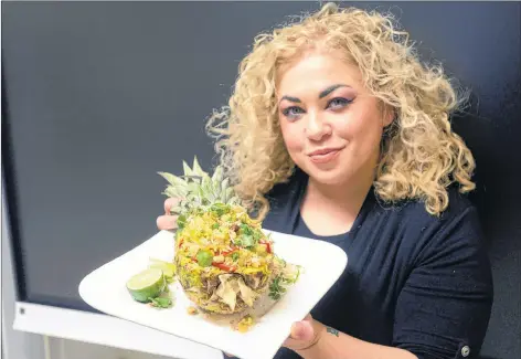  ?? MITCH MACDONALD/THE GUARDIAN ?? Chef Ilona Daniel shows her finished pineapple and shrimp fried rice celebratio­n dish, which brings together both sweet and savoury ingredient­s. The dish was inspired by a visit to a Vietnamese restaurant while Daniel was in Beijing several years ago.