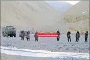  ?? AP FILE ?? Chinese troops hold a banner in this 2013 photo, saying, ‘You've crossed the border, please go back’, in Ladakh. China insists India withdraw its troops before talks can take place to settle the most protracted standoff in recent years between the two...