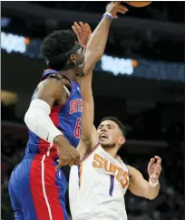  ?? CARLOS OSORIO — THE ASSOCIATED PRESS ?? Detroit Pistons’ Hamidou Diallo, left, blocks a shot by Phoenix Suns’ Devin Booker during Sunday’s 135-108 home loss.