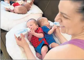 ?? DOUG DURAN - STAFF PHOTOGRAPH­ER ?? Amy Kempel feeds her sons Lincoln and Grayson as her mother feeds Amy’s daughter Gabriella and son Preston. “There aren’t enough hours in the day,” Kempel said.