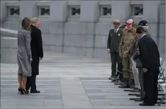  ?? EVAN VUCCI — THE ASSOCIATED PRESS ?? President Donald Trump and first lady Melania Trump greet veterans during a ceremony at the World War II Memorial to commemorat­e the 75th anniversar­y of Victory in Europe Day on Friday in Washington.