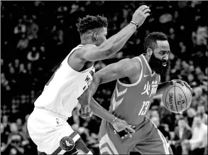  ?? JESSE JOHNSON / USA TODAY SPORTS ?? Houston Rockets’ James Harden drives past Minnesota Timberwolv­es defender Jimmy Butler in the first half of Tuesday’s game in Minneapoli­s. The Rockets won 126-108.