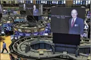  ?? RICHARD DREW / AP ?? Images of Jack Welch appear on screens above trading posts on the floor of the New York Stock Exchange on Monday. Welch died at the age of 84. His death was confirmed Monday by GE.