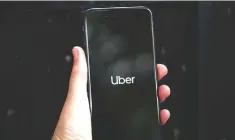  ?? — Reuters photo ?? Uber’s logo is displayed on a mobile phone in London. Uber’s valuation in its latest private investment round was more than US$70 billion, but reports said the ride-hailing giant was likely to seek a market value of close to US$100 billion.