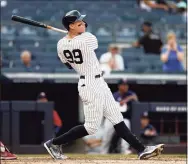  ?? Adam Hunger / Associated Press ?? Yankees outfielder Aaron Judge hits a three-run home run against the Twins during the eighth inning on Monday in New York.