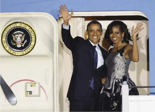  ?? ODD ANDERSEN / AFP / GETTY IMAGES ?? Barack and Michelle Obama wave ahead of boarding Air Force One at the airport in Berlin on June 19.