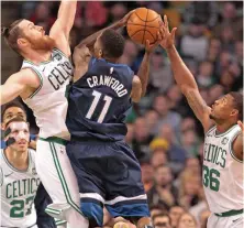  ?? STAFF PHOTO BY STUART CAHILL ?? ALL-AROUND EFFORT: Marcus Smart (right) and Aron Baynes team up to try to stop the Timberwolv­es’ Jamal Crawford during the Celtics’ 91-84 victory last night.