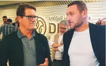  ?? Imran Malik /Gulf News ?? Fabio Capello (left) with former Italy striker Francesco ■
Totti at the Dubai Sports Council headquarte­rs.