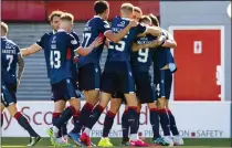  ??  ?? Billy McKay is congratula­ted by his team-mates after scoring