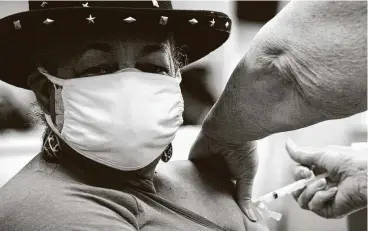  ?? Jay Reeves / Associated Press ?? Georgette Moon receives a COVID-19 vaccine at the county health department in Tuskegee, Ala., last week. The clinic has yet to reach its maximum capacity for immunizing people in the mostly Black city.