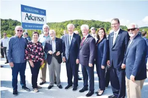  ?? Photo courtesy of the Interstate 49 Internatio­nal Coalition ?? Members of the Interstate 49 Internatio­nal Coalition at the opening of the Interstate 49 Bella Vista bypass on Thursday. From left, I49IC Gar Eisele, Mena, Arkansas; Lorie Robertson, Fort Chaffee Redevelopm­ent Authority, I49IC Fort Smith, Arkansas; Kevin Welch, I49IC, Joplin, Missouri; Gard Wayt; I49IC executive director, Shreveport, Louisiana; Arkansas Gov. Asa Hutchinson; Arkansas Department of Transporta­tion Commission­er Keith Gibson, Fort Smith; ARDOT Commission­er Marie Holder; ARDOT Commission Vice Chairman Alec Farmer, Jonesboro; and Curt Green, I49IC president, Texarkana.