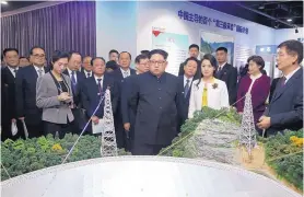  ?? YAO DAWEI/XINHUA ?? North Korean leader Kim Jong Un, center, and his wife Ri Sol Ju, visit an exhibition highlighti­ng achievemen­ts by the Chinese Academy of Sciences Wednesday.
