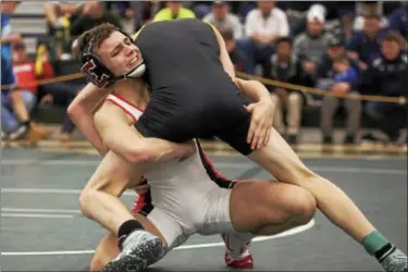  ?? JEN FORBUS — THE MORNING JOURNAL ?? Elyria’s Dylan Shawver tries to get Scott Richter’s, St. Edward, feet out from under him in the 113-pound final round of the Division I sectional tournament.