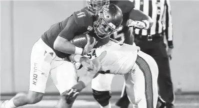  ?? STEPHEN PINGRY/AP ?? Navy linebacker Diego Fagot brings down Tulsa quarterbac­k Zack Smith during last year’s game. Fagot and Smith are both back.