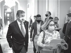  ?? AL DRAGO/NEW YORK TIMES ?? Sen. Joe Manchin and Sen. Kyrsten Sinema on Capitol Hill last week. The two Democratic senators are attracting campaign contributi­ons from business interests and conservati­ves as progressiv­es fume over their efforts to pare back the president’s domestic policy bill.