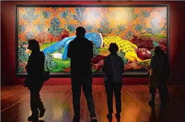  ?? PHOTOS BY GODOFREDO A. VÁSQUEZ/AP PHOTO ?? People look at a painting by Kehinde Wiley titled “Femme piquée par un serpent” at the de Young Museum in San Francisco. The painting is part of the “Kehinde Wiley: An Archaeolog­y of Silence,” exhibition.