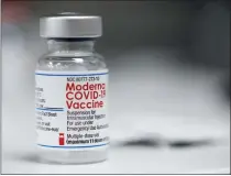  ?? (AP PHOTO/JENNY KANE) ?? A vial of the Moderna COVID-19 vaccine is displayed on a counter at a pharmacy in Portland, Ore., Monday, Dec. 27, 2021. U.S. regulators have granted full approval to Moderna’s COVID-19 vaccine after reviewing additional data on its safety and effectiven­ess.