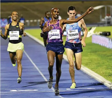  ?? PHOTO: BRYAN CUMMINGS ?? ON THE PACE: Toowoomba’s Patrick Tiernan finishes second behind British Olympic champion Mo Farah last June at the Racers Grand Prix in Kingston, Jamaica.