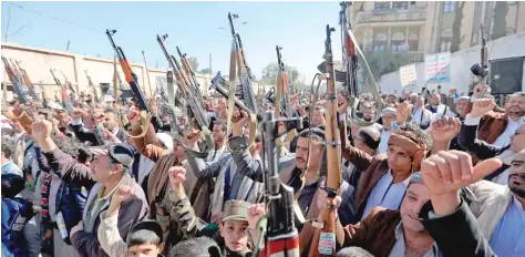  ?? — AFP ?? Supporters of the Ansar Allah gesture as they chant slogans during a demonstrat­ion against the outgoing US administra­tion’s decision to designate the movement as terrorists, in Sanaa on Wednesday.